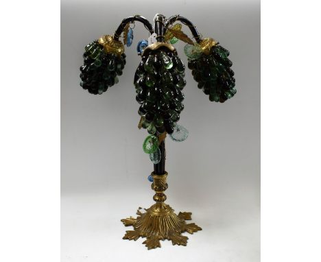 An early 20th century grape vine table lamp, three branches entwined with gilded wire, vine leaves and glass flowers, the sha