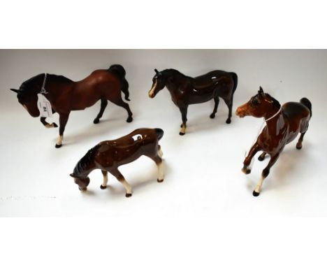 A Beswick model, of a prancing bay horse; others, similar, standing and with head down, each gloss finished; a similar pranci