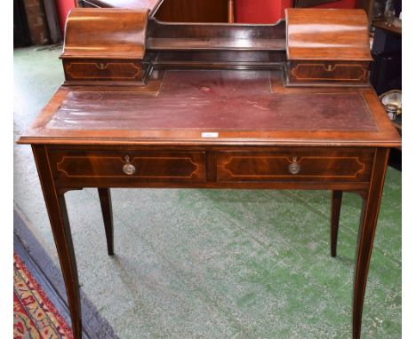 An Edwardian Carlton House type writing desk, the shaped superstructure with a pair of hinged compartments centred by a shelf