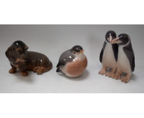 A Royal Copenhagen model, of a puppy, number 3140; others, similar, penguin group, 1190 and bird, 2266 (3)