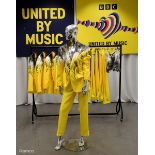 Yellow Outfits worn by backing dancers during the United by Music performance by Mariya Yaremchuck