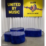 3x Asymmetrical heart shaped blue fur-covered wooden tables from countries' seating area