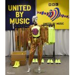 Gold Outfits worn by backing dancers during the performance by Netta of 'You Spin Me Round'