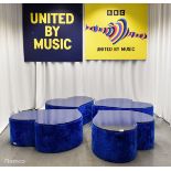 4x Asymmetrical heart shaped blue fur-covered wooden tables from countries' seating area
