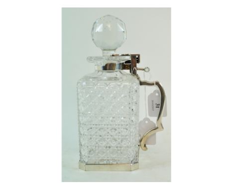 EXTRA LOT: A glass decanter and stopper, with silver plated tantalus style mounts, 24 cm high 