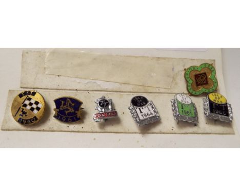 A collection of enamel motorcycling related lapel badges comprising Isle of Man 1960, 1961, 1963, 1964, 1965, 1966 and Auto C