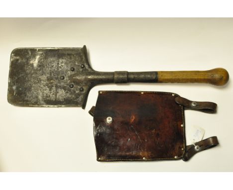 A German World War II entrenching tool, the leather harness indistinctly stamped 40 Condition report Please note that owing t