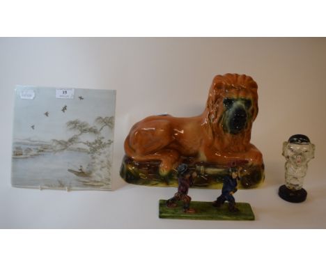 A Chinese tile, decorated a fisherman, 21 cm wide, a glass flask, in the form of a pig, a pottery lion, and a Will Young grou