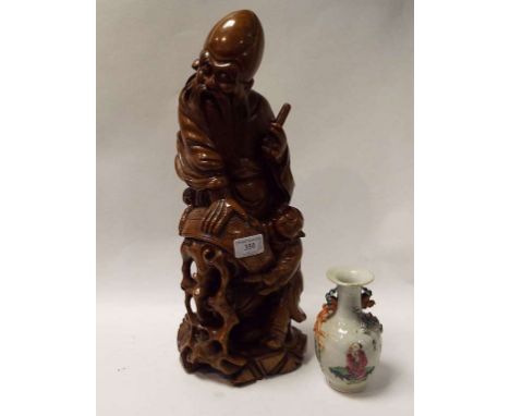 A Japanese carved wood figure, 41 cm high, and a Chinese porcelain vase, decorated figures, 14.5 cm high (2) Condition report