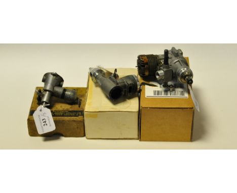 A Cox Conquest 15 2.5cc engine, with high performance glow plug motor, rear exhaust, and two other engines, Elfin 1.8cc diese
