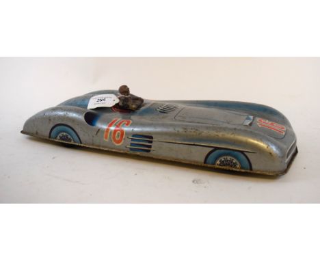 A Mercedes-Benz W-196 Streamliner tin-plate racing car, with composition figure and lithograph printed decoration, 40 cm long