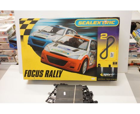 Boxed Scalextric 1095 Focus Rally with two stock cars, appearing complete but unchecked. Plus a quantity of track 