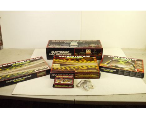Seven boxed / bagged Scalextric accessories to include C273 Electronic Lap Recorder, C706 Accessory Pack, C209 Start Light Ga