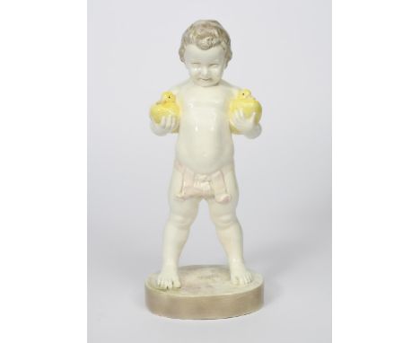 A Goldscheider Pottery model of a young boy by Brynski, model no.4287, modelled standing holding a yellow duck under each arm