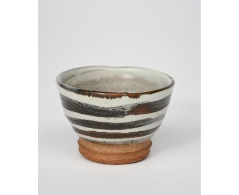 ‡ William Staite Murray (1881-1962) a stoneware tea bowl, footed, flaring conical form, painted with stripes in iron on a gre