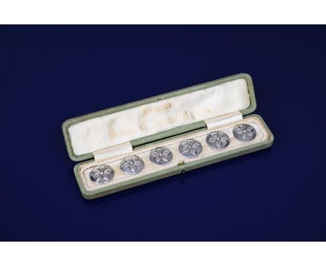 A set of six Keswick School of Industrial Arts silver buttons in original silk lined case, each circular button cast in low r