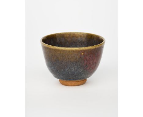 ‡ William Staite Murray (1881-1962) a stoneware tea bowl on narrow foot, covered with a running chun glaze of purple olive an