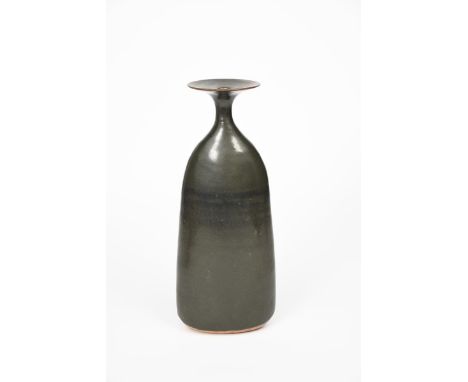 Joanna Constantinidis (1927-2000) a tall stoneware vase, tapering elliptical form with flaring top rim, covered in a pitted, 