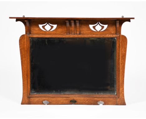 A Liberty oak overmantel mirror probably retailed by Liberty &amp; Co,  shaped rectangular form with pierced Art Nouveau flow