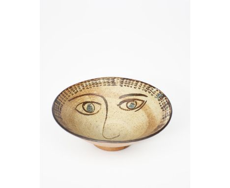 ‡ William Staite Murray (1881-1962) a stoneware footed bowl, painted with a face to the well in iron and blue on a speckled t