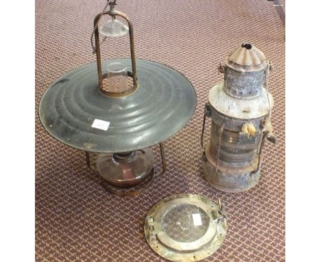 A hanging oil lamp, storm lantern and a Brass porthole