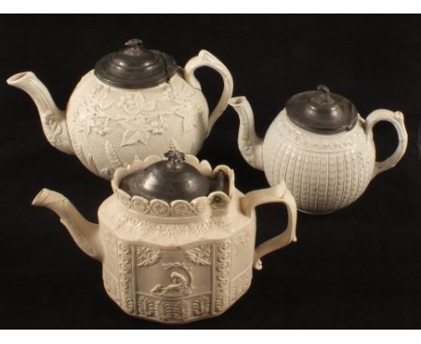 A 19th Century Dudson white glazed pewter lidded teapot, one other with relief leaf and floral decoration (cracked) plus one 