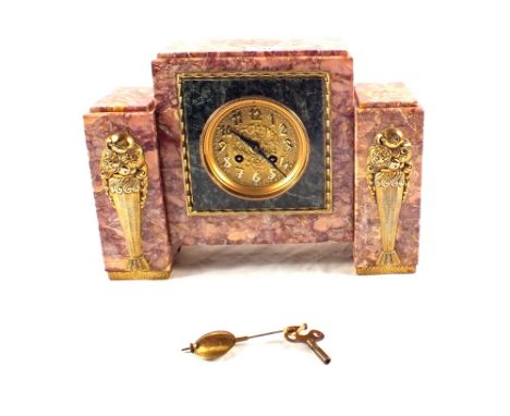 An Art Deco rouge marble and gilt metal striking mantel clock
