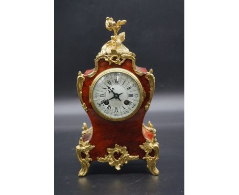 A late 19th century French tortoiseshell and brass mantel clock,&nbsp;31.5cm high, with pendulum.&nbsp; 