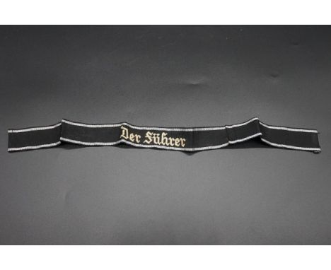 A German 'Der Fuhrer' cuff title,&nbsp;with silver thread embroidered detail, 44.5cm long.&nbsp; 