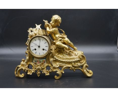 A late 19th century gilt brass and porcelain mantel clock,&nbsp;36cm wide, (no pendulum). 