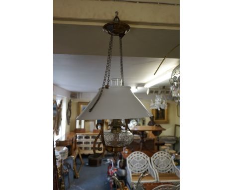 A vintage brass rise and fall ceiling oil lamp, with opaque glass shade. 