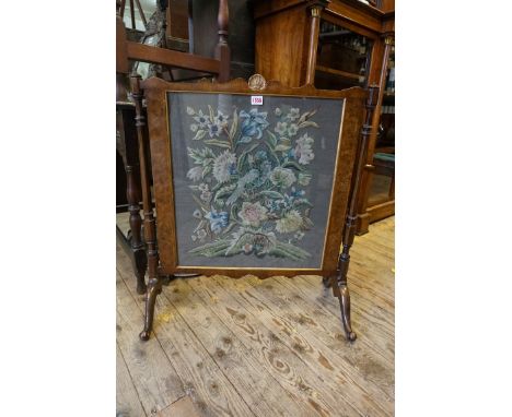 A 1930s burr walnut and feather banded firescreen, with gros point panel, 67.5cm wide.&nbsp; 