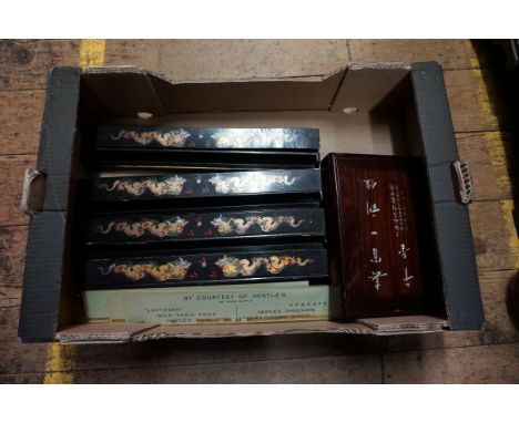 A Chinese bone and bamboo mahjong set, in hardwood case, together with a set of four gilt lacquered tile racks. 