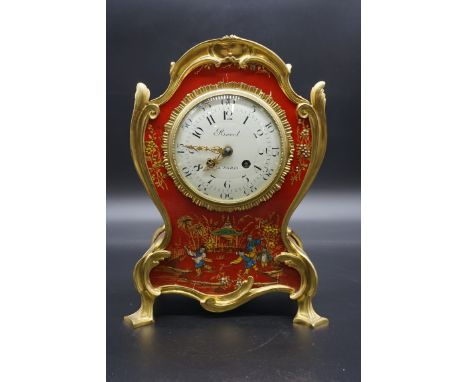 A French red lacquered chinoiserie and brass mantel clock,&nbsp;the 4 1/2in circular enamel dial inscribed 'Revel, a Paris', 