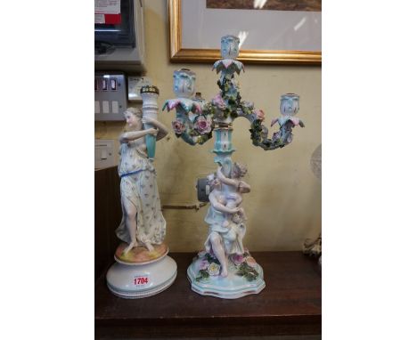 A Sitzendorf porcelain figural three branch candelabrum,&nbsp;47cm high; together with another similar figural candlestick, 3