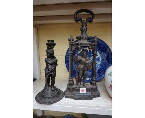 An antique cast iron doorstop,&nbsp;44cm high; together with another figural candlestick, 30cm high.&nbsp; 