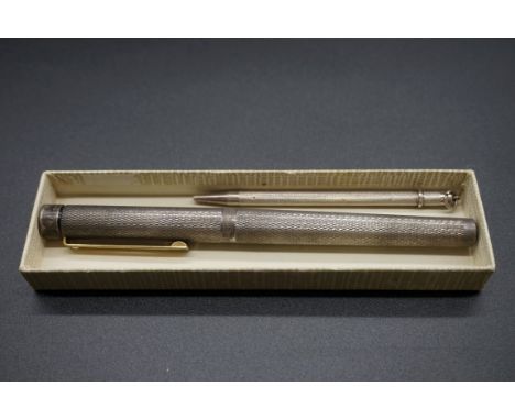 A Sheaffer silver plated engine turned fountain pen,&nbsp;with 14k nib; together with a sterling silver propelling pencil. (2