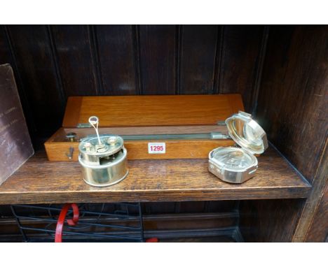 A bronze surveyor's compass, stamped 'Stanley'; together with another brass surveyor's tool; and another mahogany cased brass