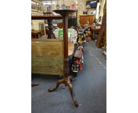 An antique carved mahogany tripod bedpost torchere,&nbsp;149.5cm high.&nbsp; 
