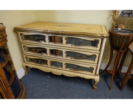 An old painted and parcel gilt commode,&nbsp;in the 18th century Continental style, with mirrored panel drawers, 140.5cm wide