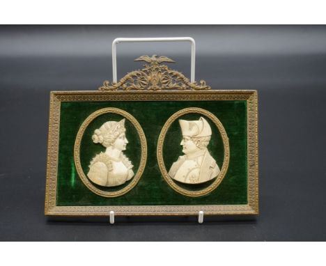 A pair of carved ivory portrait silhouette plaques of Napoleon and Josephine,&nbsp;6.5cm high, in a brass frame.&nbsp; 