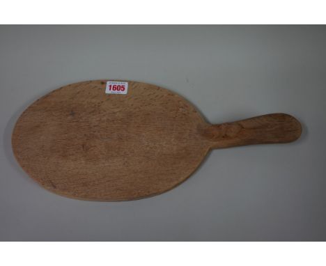 A Robert 'Mouseman' Thompson oak cheese board, 38.5cm long. 