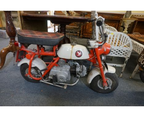 A 1968 Honda 50cc monkey bike,&nbsp;in 'barn find' condition, the odometer displaying 261 miles, tax disc expiry Nov70, Regis