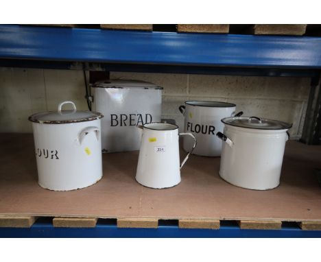 A vintage enamel bread bin, three flour bins and a jug