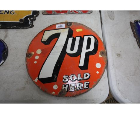 A circular enamel advertising sign for "Seven Up", approx. 12" dia. 