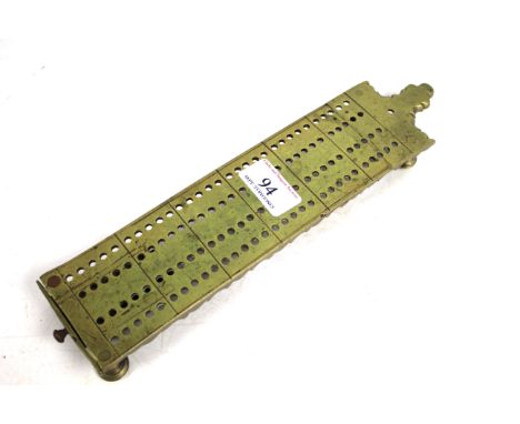 An antique brass cribbage board fitted with a small drawer containing marker pins