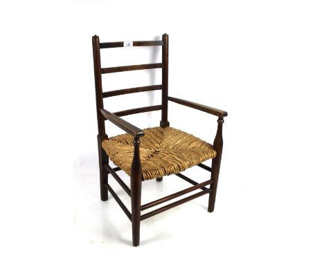 An early 20th Century child's ladder back, rush seated chair