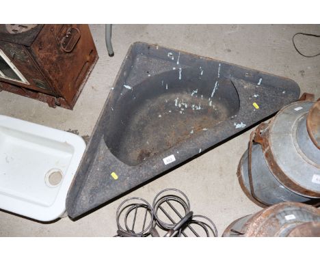 A cast iron corner feed trough 
