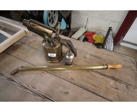 A vintage brass and iron blow lamp, a smaller example and a brass garden spray