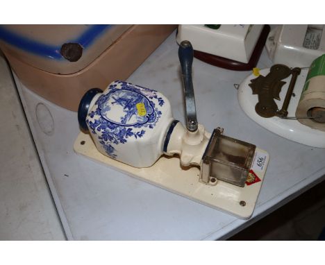 A wall mounting coffee grinder with Dutch windmill scene 